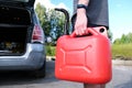 A red plastic gas canister. The man is going to refuel the car Royalty Free Stock Photo