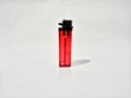 Red plastic gas lighter. Gas lighter isolated on white background. Closeup shot, top view Royalty Free Stock Photo