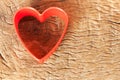 Red plastic heart shaped on old wood Royalty Free Stock Photo