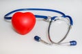 Red Plastic Heart And Stethoscope On White Background