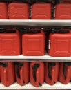 Red plastic jerrycan canister production on the shelf  in store for sale Royalty Free Stock Photo