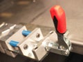 Red plastic lever of an industrial mechanical clamping device