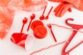 Red plastic objects scattered on white