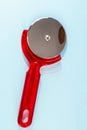 A red plastic pizza cutter with a silver handle Royalty Free Stock Photo