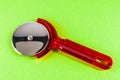 A red plastic pizza cutter with a silver handle Royalty Free Stock Photo
