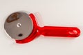 A red plastic pizza cutter with a silver handle Royalty Free Stock Photo