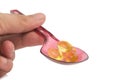red plastic spoon.Capsules fish oil isolate on white background