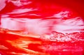 Red plastic surface in water, abstract background Royalty Free Stock Photo