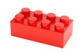 Red plastic toy building block on white background