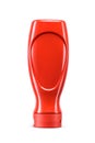 Red plastic upside down squeeze bottle with ketchup isolated on a white