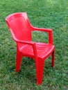 Red plastic vacant chair grass Royalty Free Stock Photo