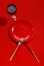 Red plate, knife and fork on a red table. Top view. Copy space Royalty Free Stock Photo