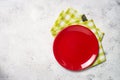 Red plate and tablecloth on light stone table. Royalty Free Stock Photo