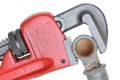 Red plumbers pipe wrench and plumbing component Royalty Free Stock Photo