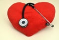 Red plush heart and stethoscope on the table Royalty Free Stock Photo