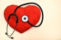 Red plush heart and stethoscope on the table Royalty Free Stock Photo