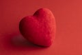 red plush suede heart on a red background Royalty Free Stock Photo