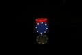 Red pocker chips stack with a blue chip in front isolated on black with reflection Royalty Free Stock Photo
