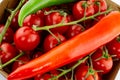 Red pod pepper on a background red cherry tomato on a branch close-up design vegetable bright