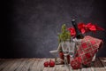 Red Poinsettia flowers, champagne bottle, empty champagne flutes and Christmas ornament on dark background. Christmas. New Year Royalty Free Stock Photo