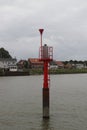 Red pole in river Hollandsche Ijssel to guide ships to right direction