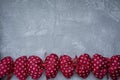 Red polka dot bows. Plush bow A toy. Light background under the concrete. Space for text