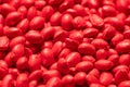 Red polymer dye in granules, background texture Royalty Free Stock Photo