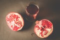 Red pomegranate juice in a glass/Pomegranate fruit and juice in glass on dark background, top view