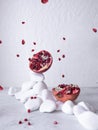 Red pomegranate on a white background. Fruit on stones.