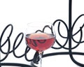 Red pomegranate wine in glass and metal wine bottle holder Royalty Free Stock Photo