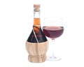 Red pomegranate wine in glass and straw wine bottle Royalty Free Stock Photo