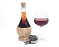 Red pomegranate wine in glass and straw wine bottle with shabbat metal decoration Royalty Free Stock Photo