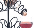 Red pomegranate wine, wine straw bottle and iron wine bottle holder Royalty Free Stock Photo