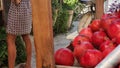 Red pomegranates on the sellers counter and next to the traditional scale