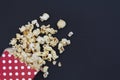 Red popcorn box on black background with copy space Royalty Free Stock Photo
