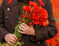 Red poppies in hands in spring field