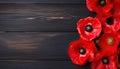 Red poppies on wooden background. Top view with copy space