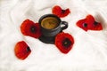 Red poppy flowers, black cup of coffee on a white background. Royalty Free Stock Photo