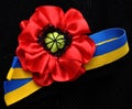 Red poppy flowers and ribbon Ukrainian flag