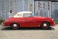 Red Porsche Convertible Speedster in front on metal building Royalty Free Stock Photo