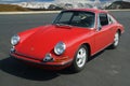 1967 Red Porsche 911 coupe in front of Rockies