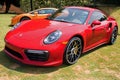 Red Porsche Sports Car in Grass Field Royalty Free Stock Photo