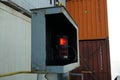 Red port side navigational lights of the loaded container ship.