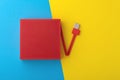 Red portable speaker on blue and yellow background Royalty Free Stock Photo