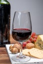 Red porto and cheese pairing, blue matured stilton English cheese served as dessert with walnuts and glass ruby porto wine