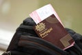 Red Portugal passport of European Union with airline tickets on touristic backpack