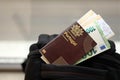 Red Portugal passport of European Union with money and airline tickets on touristic backpack