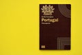 Red Portugal passport of European Union on yellow background close up