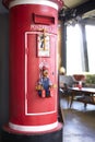 Red post booth and wooden doll Royalty Free Stock Photo