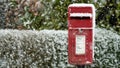 Red post box at Christmas covered with falling snow Royalty Free Stock Photo